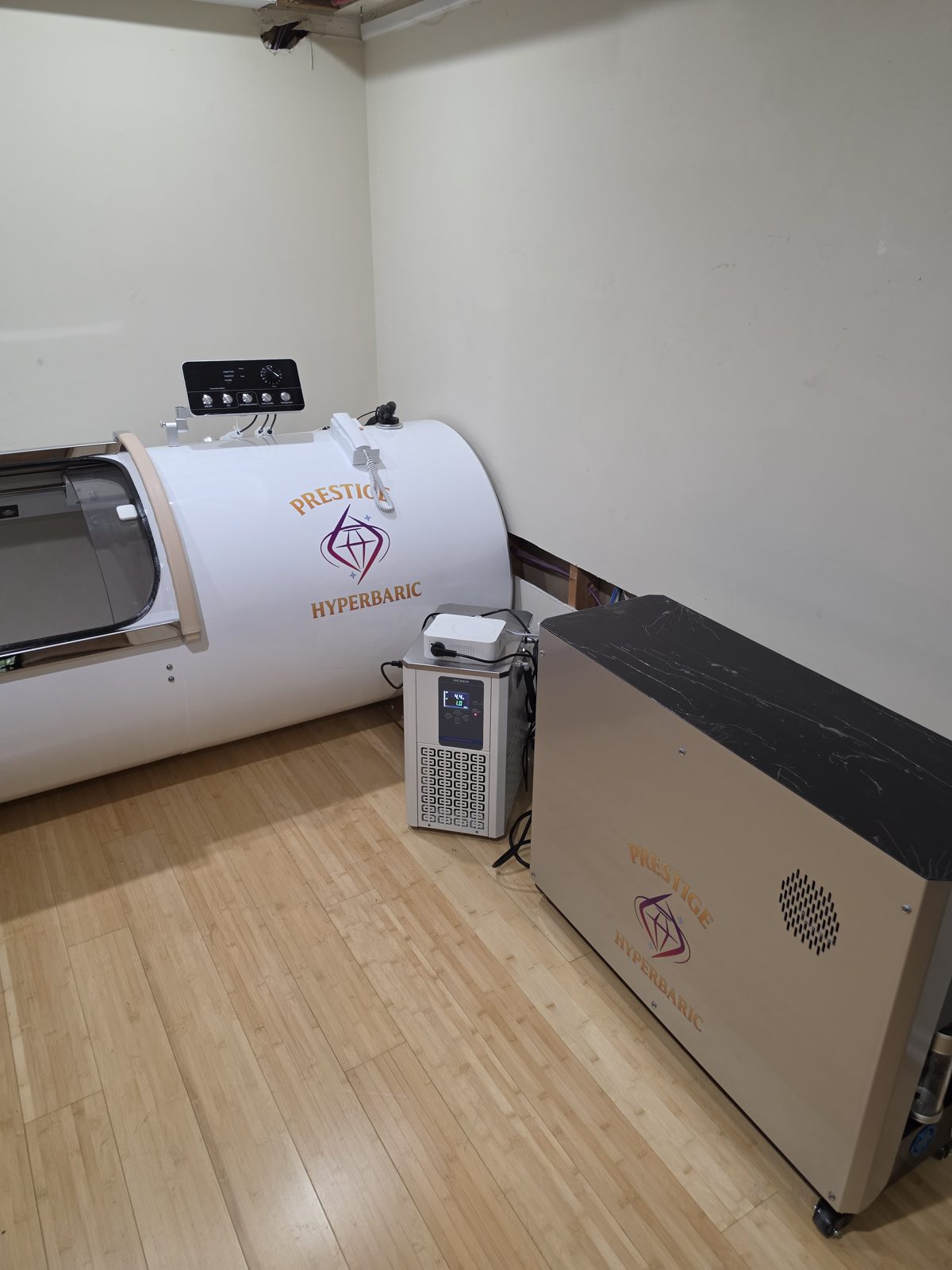 Wide view of the basement wellness room with the Grand Vessel of Power and its system cabinet