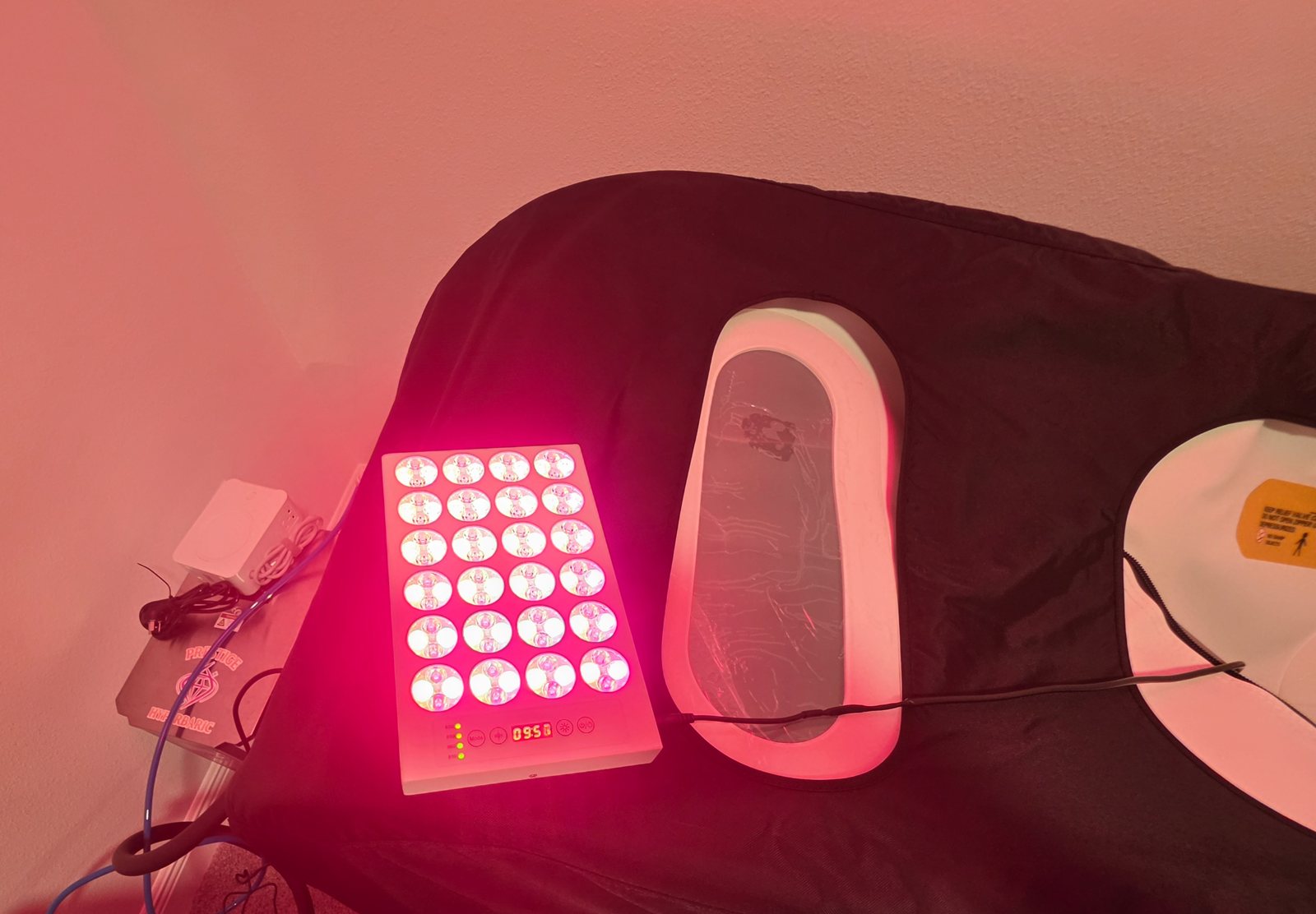 Compact Soft Shell Red Light Panel on its stand beside a soft-shell chamber