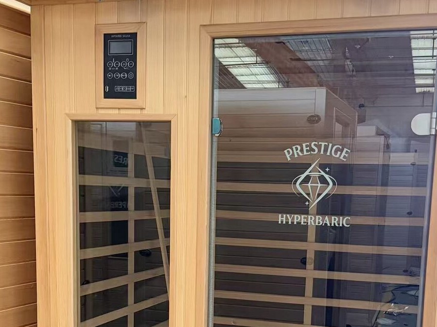 Prestige Carbon Duo sauna in the showroom, shown as the setting for the sauna collection, not an installed SARL panel